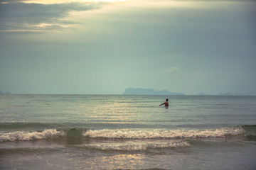 Fototapeta premium One man in the sea fishing during sunset with scenic sea view