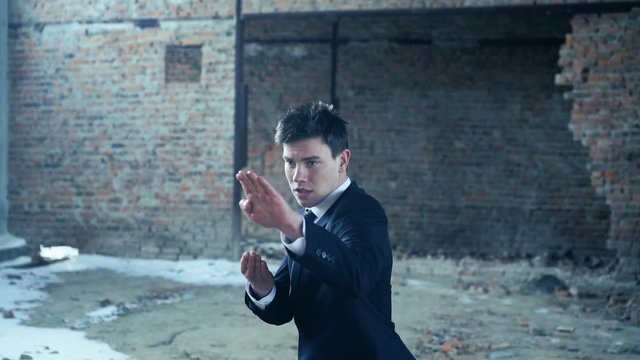 Businessman showing movements of martial arts. 4k