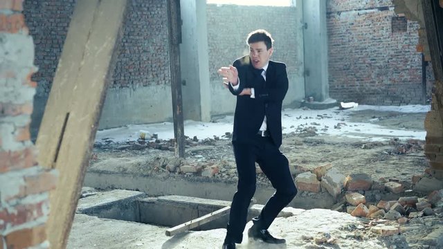 Businessman showing movements of martial arts. 4k