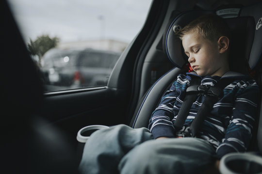 Boy Sleeping While Sitting On Car Seat