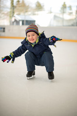 Winter sport. Small boy skating on ice