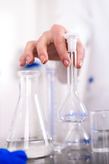 Hand of a Scientist Holds Laboratory Glassware
