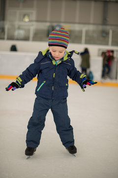 Winter sport. Small boy skating on ice