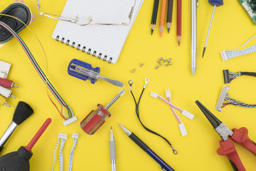 Components, records and tools on the table of a researcher are related to applied science and engineering.