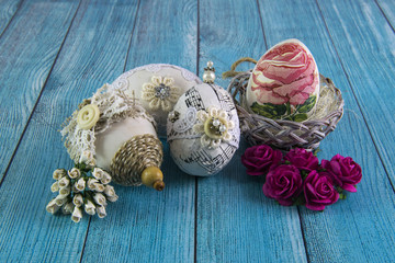 Vintage Easter Eggs with flowers on a blue background of the village