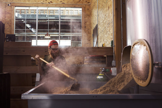 Brewer working on machinery at brewery