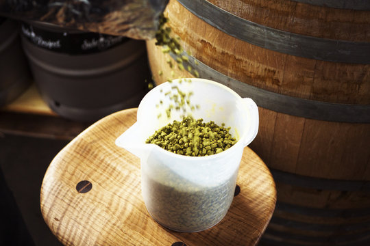 High angle view of pellets hops been poured in beaker at brewery