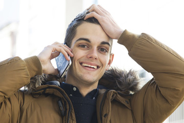 Fototapeta premium young man with the phone on the street talking about
