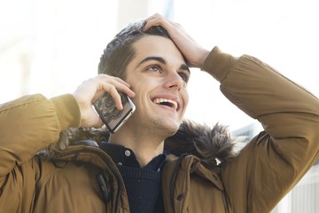 young man with the phone on the street talking about