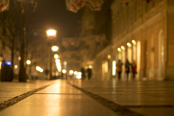 Blurred background. Blurred people walking through city street. winter night