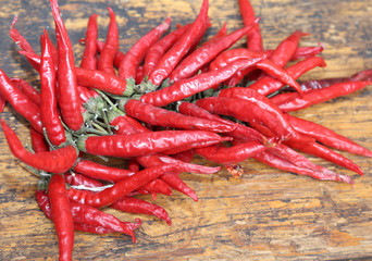 red hot peppers on wooden table at  market