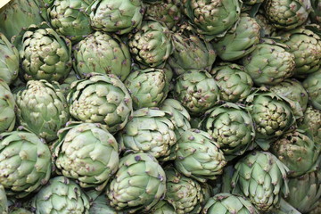 green background of artichokes for sale
