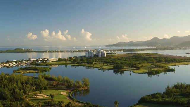 St Maartin Aerial v14 Flying low over Mullet Bay golf course panning at sunrise.