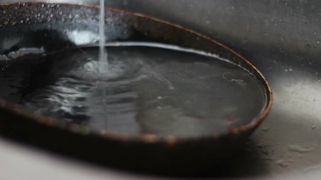 Dirty pan lies in the kitchen sink