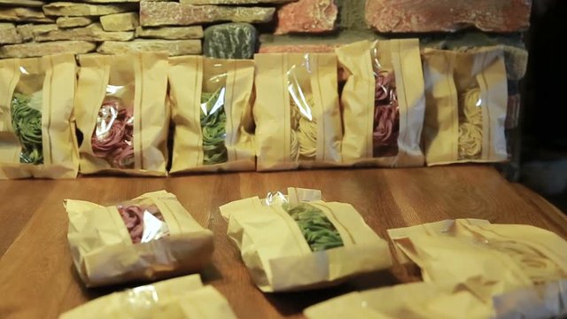 Multicolored pasta uncooked in a paper package