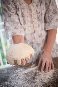 Woomens hands holding a finished clean dough