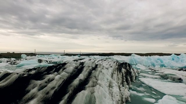 The camera sinks at one of the most beautiful natural sights - the ice of Jökulsarlon. It is a large glacial lake in southeast Iceland, on the edge of Vatnajökull National Park.