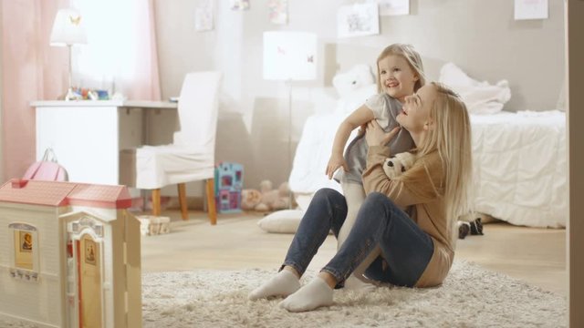 Cute Little Girl Runs Towards Her Young Mother and They Hug. Children's Room is Pink, Has Drawings on the Wall and is Full of Toys. Slow Motion. Shot on RED EPIC-W 8K Helium Cinema Camera.