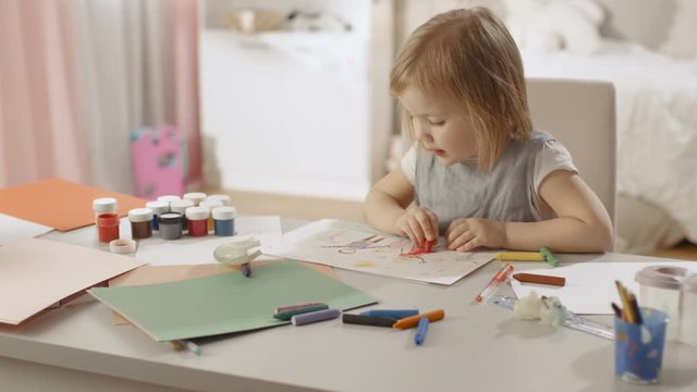 Cute Little Girl Sits at Her Table and Draws with Crayons. Her Room Is Pink and Cosy. Shot on RED EPIC-W 8K Helium Cinema Camera.