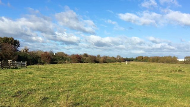 Empty pasture in autumn stable camera clip with clouds slowly moving in the sky