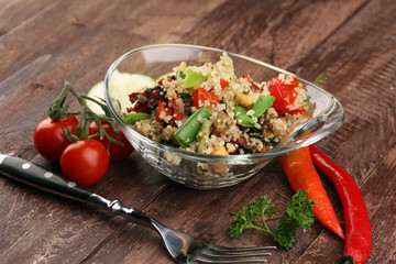 Delicious vegetarian quinoa salad with bell pepper, cucumber and tomatoes