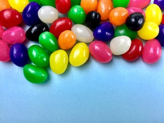 Fototapeta na wymiar Jelly beans on a light blue background with copy space