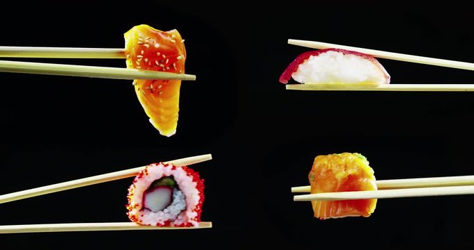 Macro shot of sushi,sashimi,uramaki and nighiri.typical Japanese dish consisting of rice, salmon or tuna,shrimp and fish eggs on a black background.Concept:Japanese restaurant,sushi,oriental tradition
