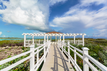 Fototapeta na wymiar Amazing beautiful view of a gazebo path leading toward the beach and ocean on Cuban Cayo Guillermo Island 