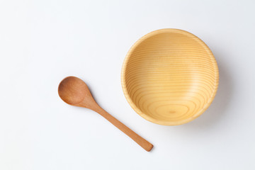 Wooden bowl and spoon on white background