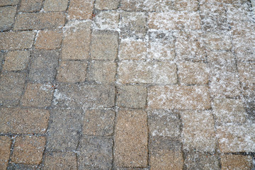 winter ice melting salt on the brick ground