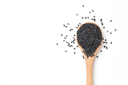 Black sesame seeds in wooden spoon