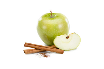 Green apple and cinnamon sticks on white
