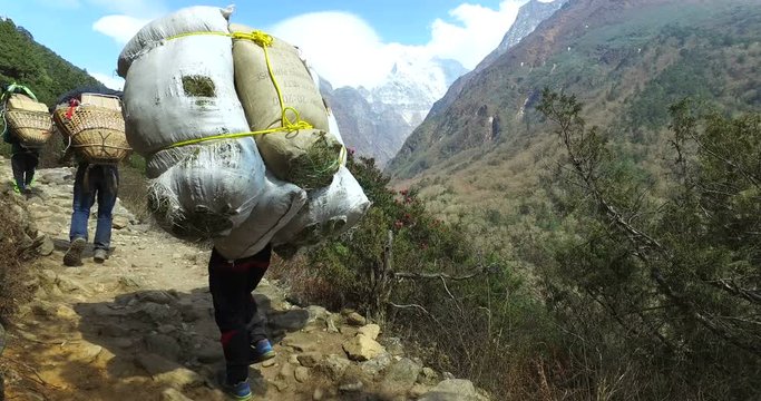 District Namche Bazar, Nepal- May 28, 2016: Carrying cargo in the Himalayas, Nepal, the trek to Everest Base Camp. 