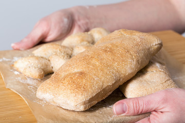 Female hands holding homemade ciabatta bread