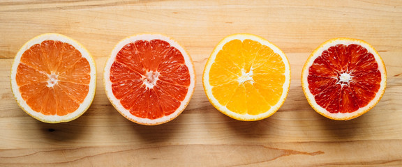 Healthy citrus fruit arranged on a wooden table and photographed from above