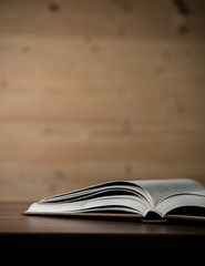 Close up of opened book on wooden table. Education concept.