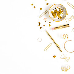 Beauty blog background. Gold style feminine accessories. Golden tinsel, scissors, pen, rings, necklace, bracelet on white background. Flat lay, top view.