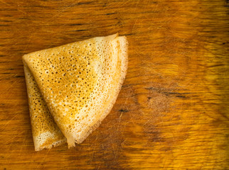 Thin Pancakes on a Wooden Background Top View