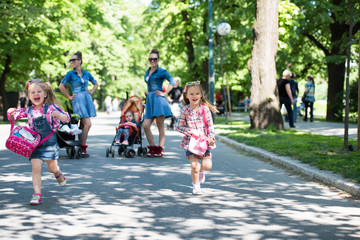 twins mother with children  in city park