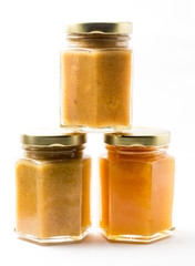 Jars of generic baby food on white background