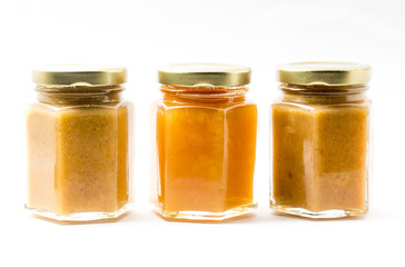 Jars of generic baby food on white background