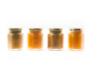 Jars of generic baby food on white background