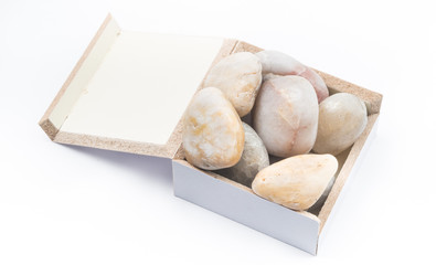 Pebbles inside a box on white background