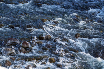Raging water in threshold of the mountain river