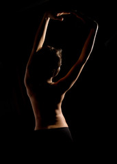 Elegant curves of female shoulders and neck, Redhead girl on a dark background