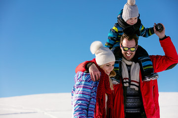 Attractive family having fun in a winter park on mountain