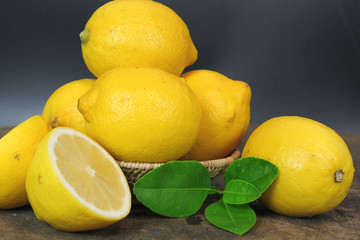 fresh lemon whole and slice with lemon leaf