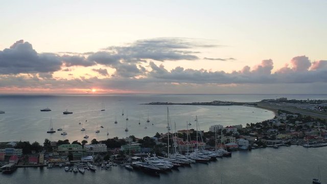 St Maartin Aerial v68 Flying low over Simpson Bay Lagoon panning with airport views at sunset.