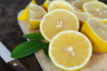 fresh lemon whole and slice with lemon leaf
