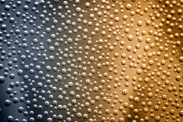 Air bubbles on the wall of the vessel with water close-up as a background.